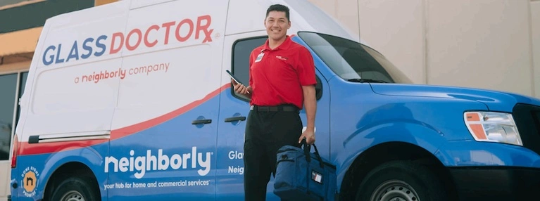 Glass Doctor Tech standing in front of company truck. Glass Doctor A Neighborly Company.