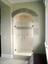 swinging glass shower doors with arched top and decorative glass