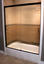 framed shower enclosure with sliding doors and blurred glass