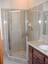 hexagonal framed shower enclosure with swinging door