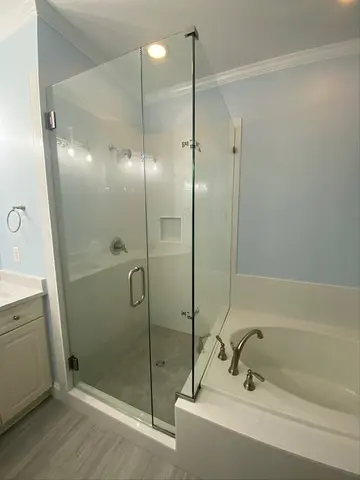 90-degree frameless glass on a walk-in shower with a swing door and brushed nickel hardware by Glass Doctor of Raleigh