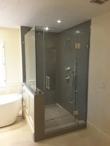A custom frameless glass shower enclosure and glass shower door by Glass Doctor of Tampa Bay.