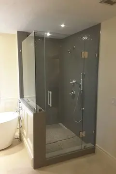 A custom frameless glass shower enclosure and glass shower door by Glass Doctor of Tampa Bay.