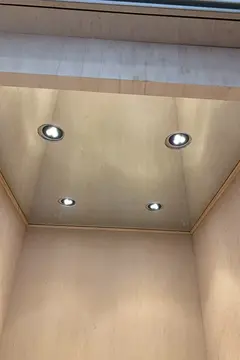 Ceiling mounted mirror with four round cutouts for lights installed by Glass Doctor of Nashville.